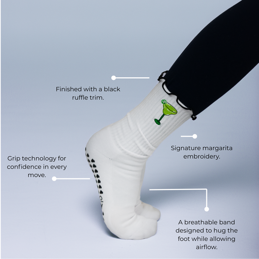White sock with black ruffle trim and margarita embroidery on a light blue background